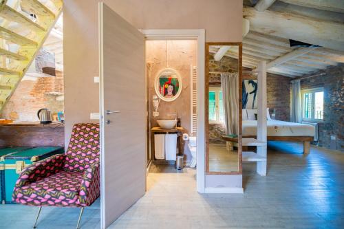 a living room with a couch and a bed at Inside the Wall in Lucca