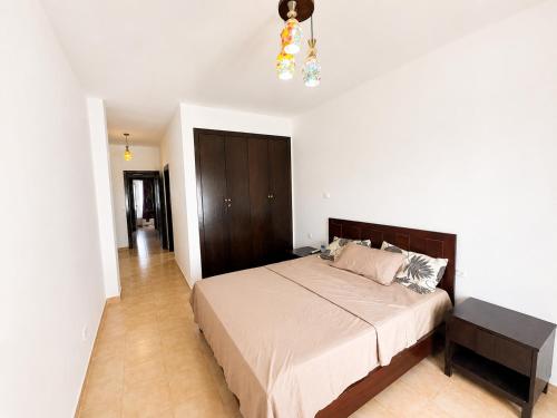a bedroom with a large bed and a chandelier at Saidia Marina in Saïdia