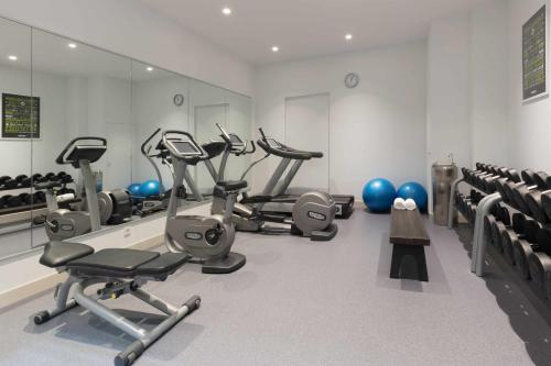 a gym with several treadmills and exercise bikes at Wittenberg by Cove in Amsterdam