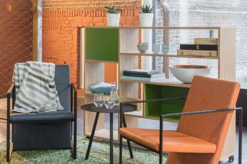 a room with two chairs and a table at Wittenberg by Cove in Amsterdam
