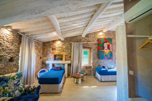 a living room with two beds and a fireplace at Inside the Wall in Lucca