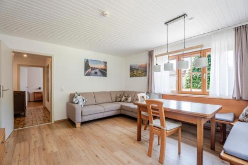 a living room with a couch and a table at Ferienwohnung Bergfranzenhof in Oppenau