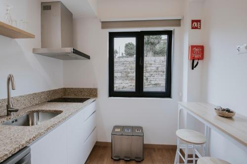a kitchen with a sink and a window at Quinta do Codeçal in Vila Real