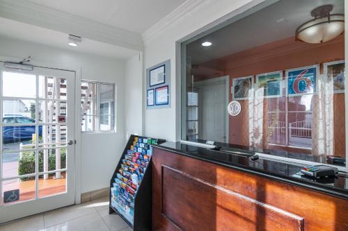 a salon with a wooden counter and a mirror at Motel 6 Gardena in Gardena