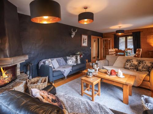 a living room with a couch and a fireplace at Chalet Bolay in Montriond