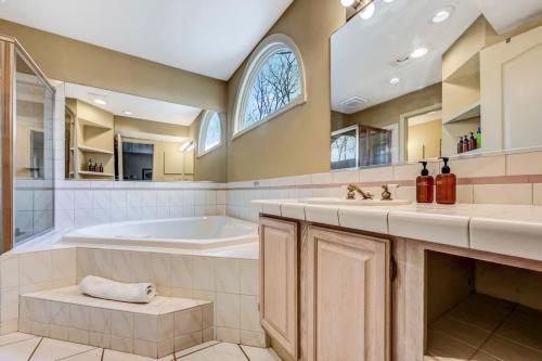 a large bathroom with a tub and a sink at Poconos Paradise Lakeskihikewater Parkkids in Lake Harmony