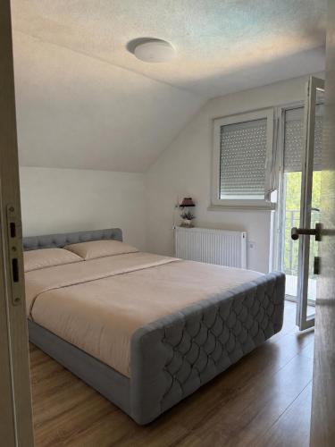 a bedroom with a large bed in a room at Villa Tri tačke in Debeljaci