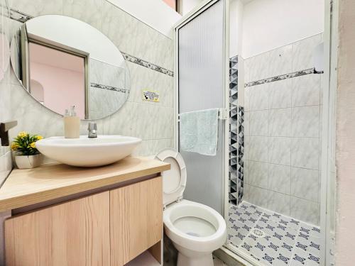 a bathroom with a sink and a toilet and a shower at HOTEL HERMOSO CARIBE in Tolú