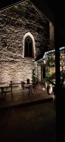 a patio with a table and chairs in front of a building at la suite 4 de Saint Jean in Crémieu