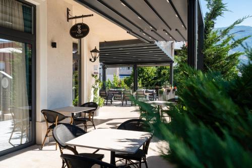 a patio with tables and chairs on a building at Hotel Eden in Budva