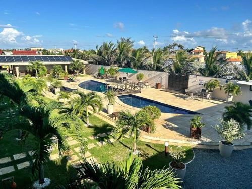 an overhead view of a resort with a pool and palm trees at Pousada Bellissima Italia in Luis Correia