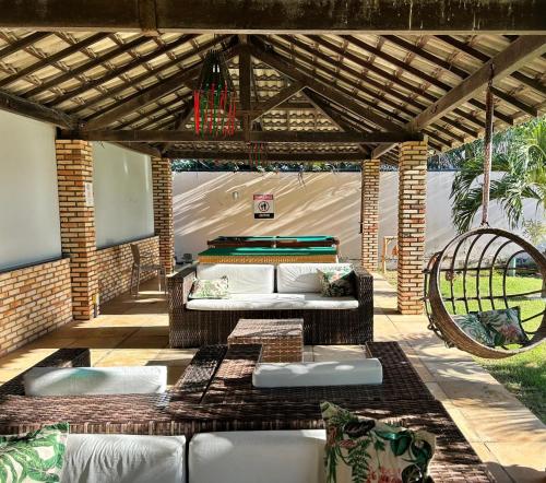 an outdoor patio with a couch and a tent at Pousada Bellissima Italia in Luis Correia