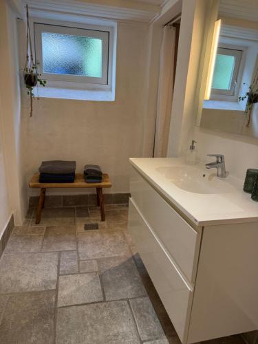 a bathroom with a sink and a mirror at Brøndums B & B in Hjørring