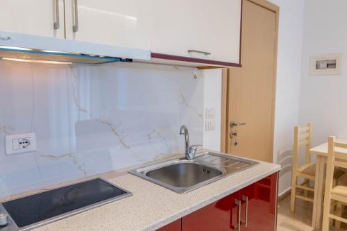 a kitchen with a sink and a counter top at Villa HENA in Sarandë