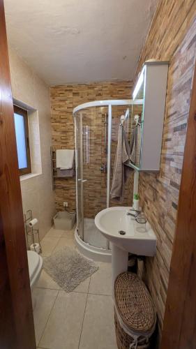 a bathroom with a shower and a sink and a toilet at Historical Apartment in Bormla in Cospicua