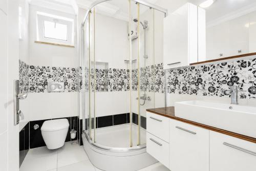 a bathroom with a shower and a toilet and a sink at Villa Kubra in Dalyan