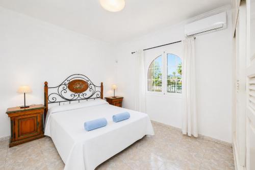 a white bedroom with a bed and a window at Villa Alisa in Tías