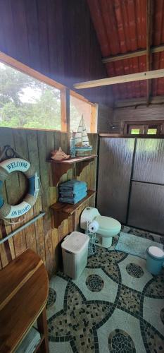 a bathroom with a toilet and a sink at SEGUNDA BRISA in Tucker Bight