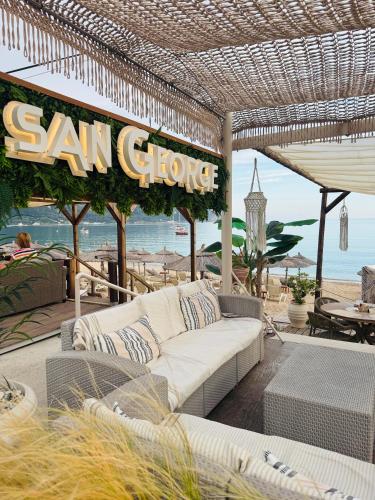 a patio with a white couch and a sunoco sign at Art House Near to Saint George Beach by Konnect in Págoi