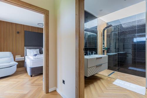 a bathroom with a toilet and a sink and a shower at Elite House Gold Apartment in Leányfalu
