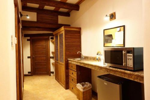 a kitchen with a counter top with a microwave at Hotel Quinta Mision in Creel