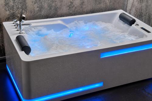 a white sink with blue lights in a bathroom at Ceylon Breeze Sigiriya in Sigiriya
