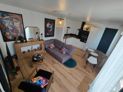 a living room with a couch and a table at Maison chic & chill in Saint-Brieuc