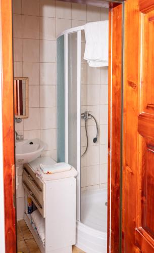 a bathroom with a tub and a sink and a shower at Penzion Trstená in Trstená