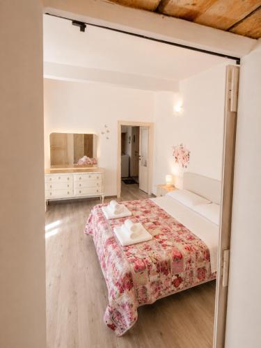 a bedroom with a bed and a dressing room at Lescen White Residence - swimming pool in Lezzeno