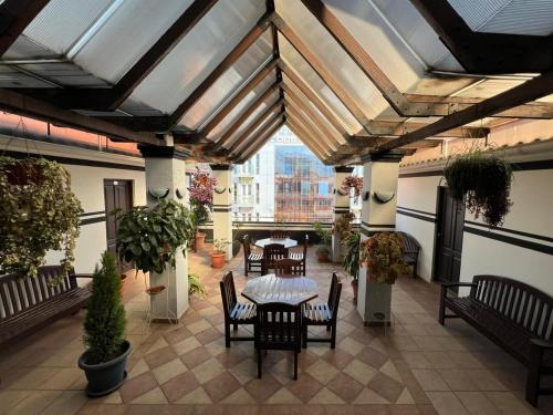 eine Terrasse mit Tischen und Stühlen in einem Gebäude in der Unterkunft City Hotel in Cochabamba