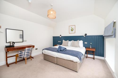 a bedroom with a bed and a desk and a computer at Shore Hotel in Balintore
