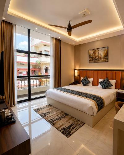 a bedroom with a large bed and a large window at Hotel Shakuntla Palace - 400 Meters away from Vishnu Pad Temple 7 mins walk in Gaya