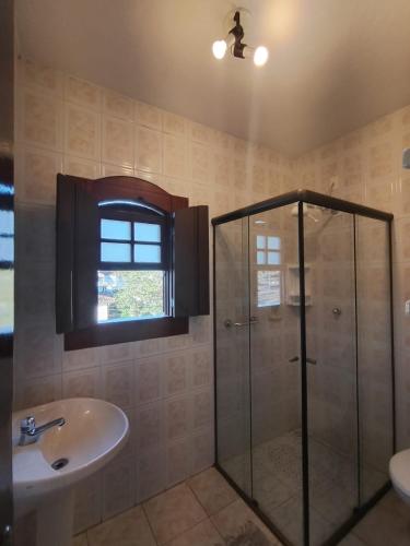 a bathroom with a shower and a sink at Pousada Alecrim Dourado in Paraty