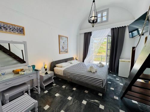 a bedroom with a bed and a dresser and a window at Tritonas Rooms in Kamari