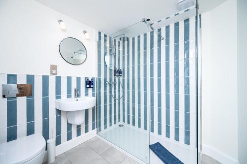 a bathroom with a shower and a toilet and a sink at Shore Hotel in Balintore