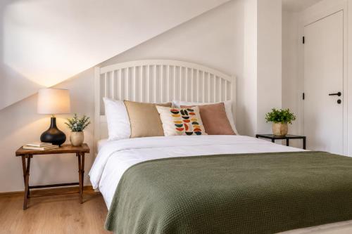 a bedroom with a large bed with a green blanket at Dana apartment with Garden near Tara National Park in Bajina Bašta