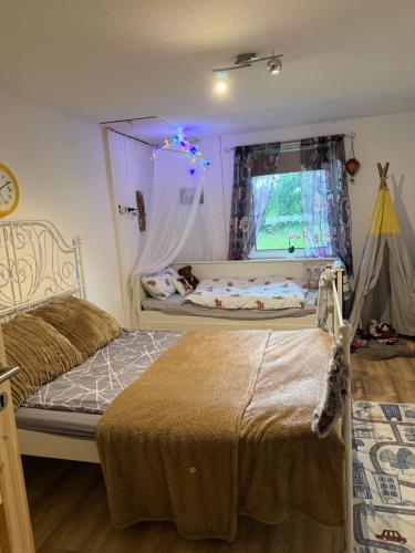 a bedroom with two beds and a window at The Cottages - Pet Friendly in Meißendorf