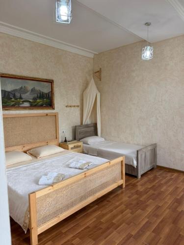 a bedroom with two beds in a room at Nugo Villa in Kutaisi