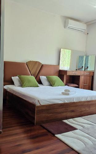 a bedroom with a large bed with a mirror at G - Apartments in Kumanovo