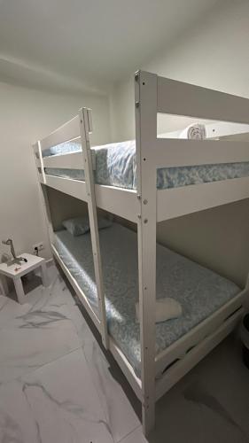 two bunk beds in a room with a wall at SIMPL hostel Oquendo in Madrid