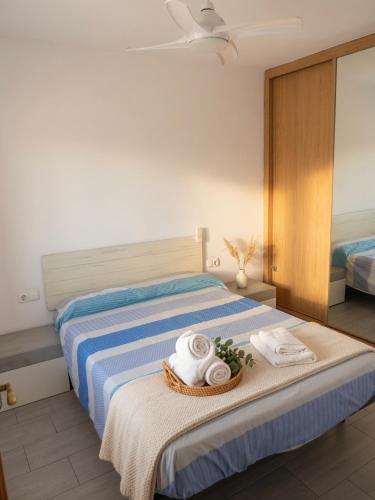 a bedroom with a bed with towels on it at COSTA DE ALMERIA PLAYA in Almería