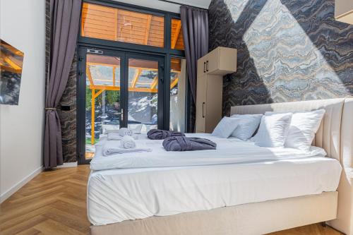 a bedroom with a large white bed in a room at Elite House Platina Apartment in Leányfalu