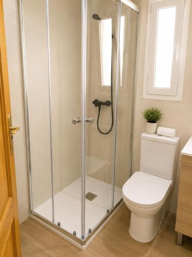 a shower stall in a bathroom with a toilet at COSTA DE ALMERIA PLAYA in Almería