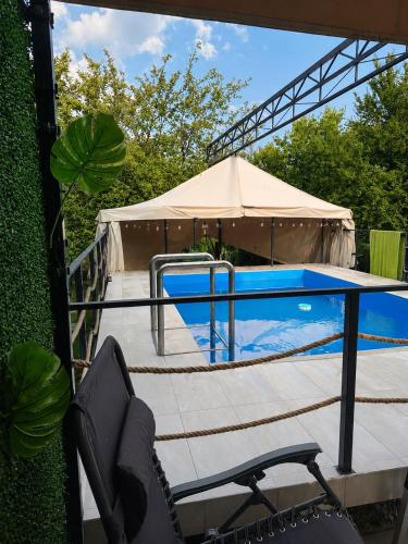 a swimming pool with a table and a tent at Weekend Joy Home Visoko in Visoko