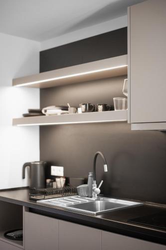 a kitchen with a sink and a counter top at Aurelia Boutique - Suites in Rhodes Town