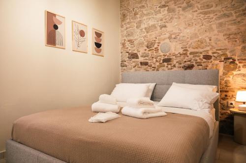 a bedroom with a bed with towels on it at Kallia Castle apartments in Chios