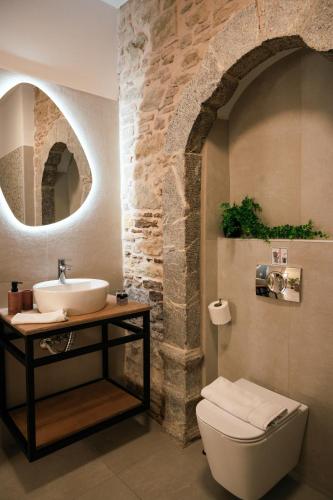 a bathroom with a sink and a toilet at Kallia Castle apartments in Chios