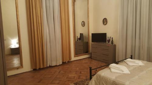 a bedroom with a bed and a dresser with a mirror at Garden Suite in Genova