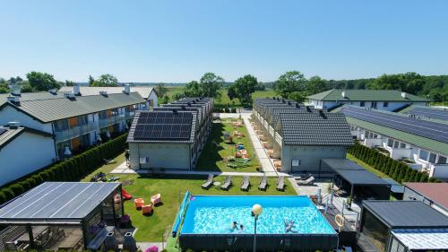 an overhead view of a swimming pool with buildings at Domki Gala- blisko plaży, basen z podgrzewaną wodą , sauna , parking in Grzybowo
