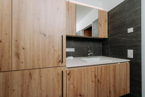 a bathroom with a sink and a mirror at KitzSki Living in Kitzbühel